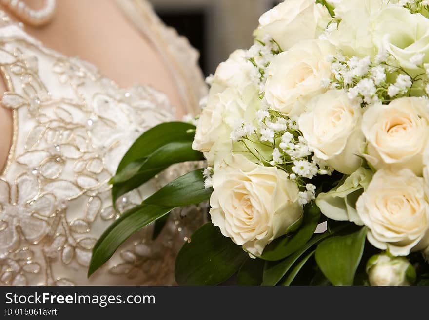 Details of the bride's dress and bouquet of flowers. Details of the bride's dress and bouquet of flowers