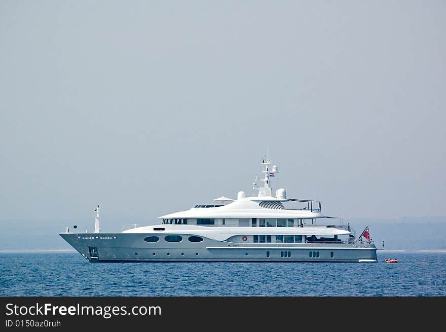 View on a majestic yacht ploughs water of the Mediterranean sea. View on a majestic yacht ploughs water of the Mediterranean sea