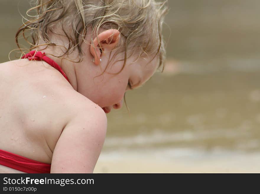 Little girl playing on the beach. Little girl playing on the beach