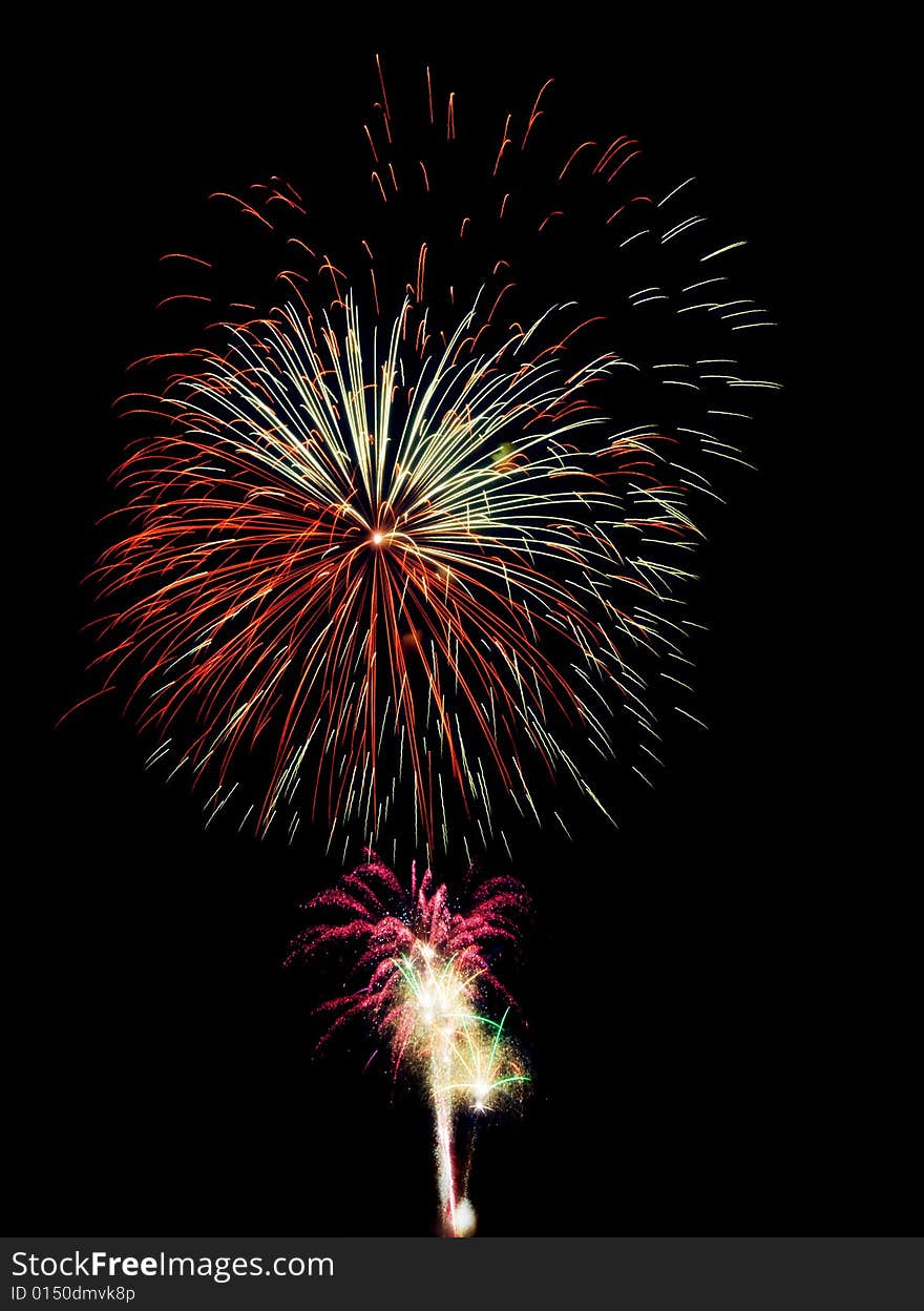 Fireworks composition photographed with long exposure, isolated on black.