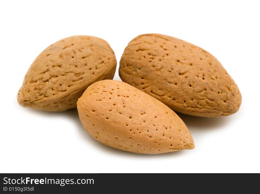 Three almonds on white background