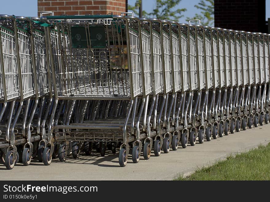 Big stack of shopping carts outside of a store