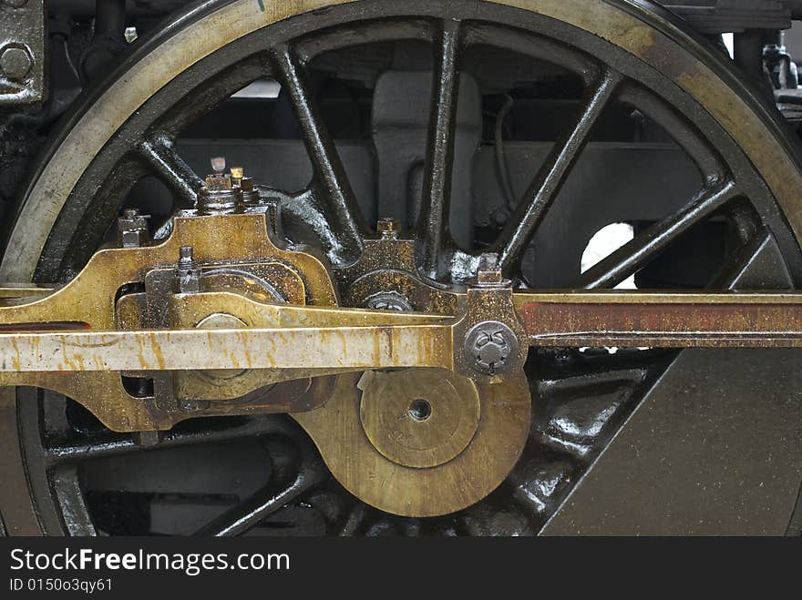 Wheel of old steam engine stained by oil used for lubrication. Wheel of old steam engine stained by oil used for lubrication.