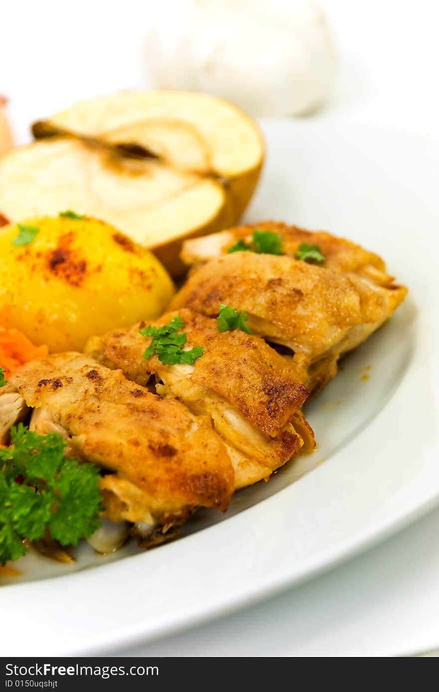 Roasted chicken with apple and fried potatoes.