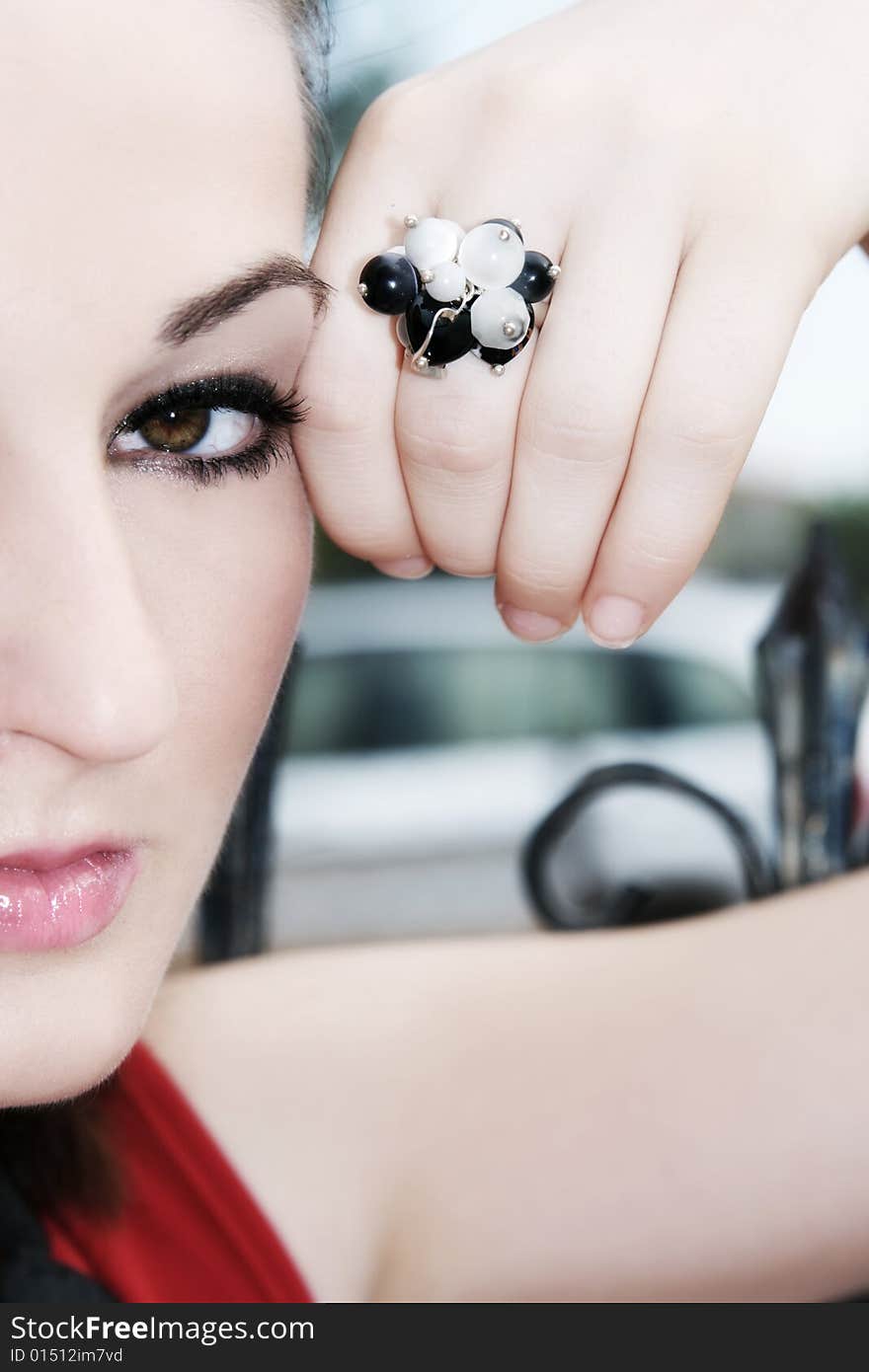 A beautiful young brunette woman wearing a black and white ring. A beautiful young brunette woman wearing a black and white ring