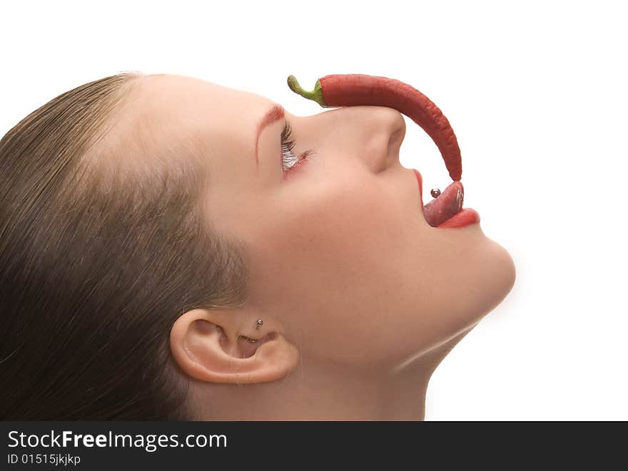 Nice young girl with red cayenne isolated over white. Nice young girl with red cayenne isolated over white