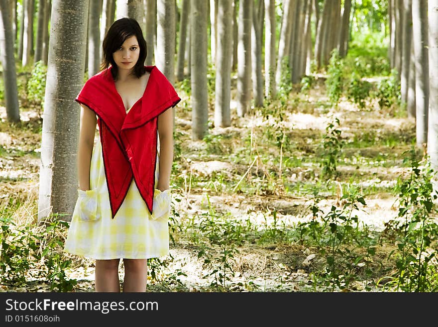 Beautiful woman staring at camera in a forest. Beautiful woman staring at camera in a forest.