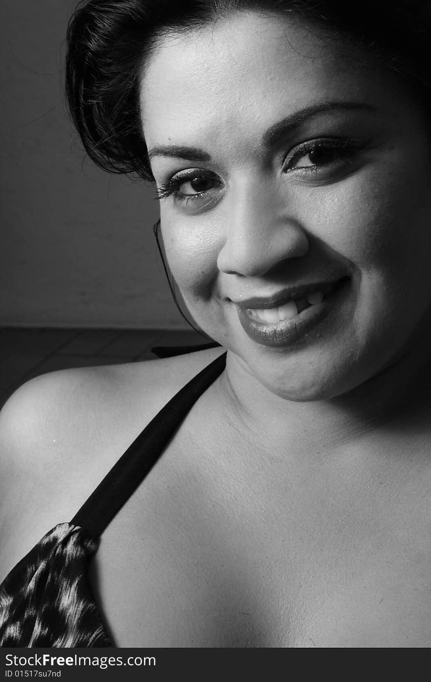 Young hispanic female smiling. Image taken in black and white. Young hispanic female smiling. Image taken in black and white.