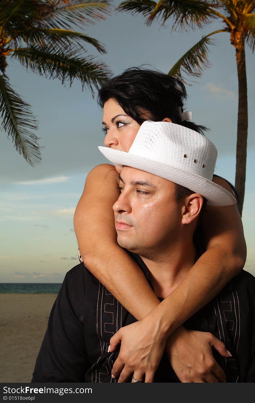 Young couple on vacation in a tropical scene. Young couple on vacation in a tropical scene.