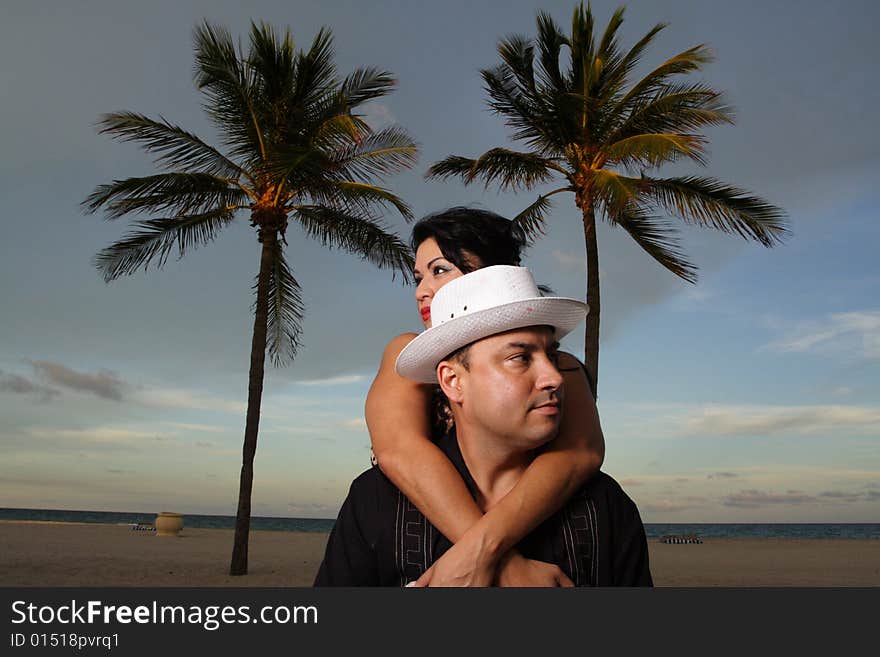 Young couple on vacation in a tropical scene. Young couple on vacation in a tropical scene.