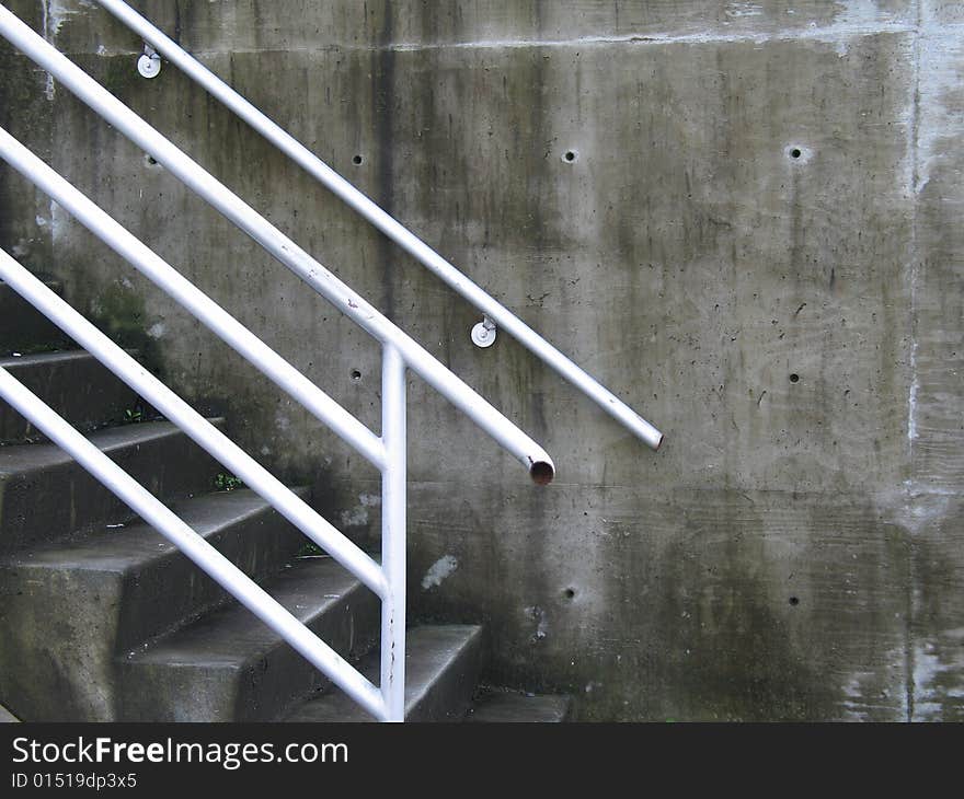 Concrete steps and white railing