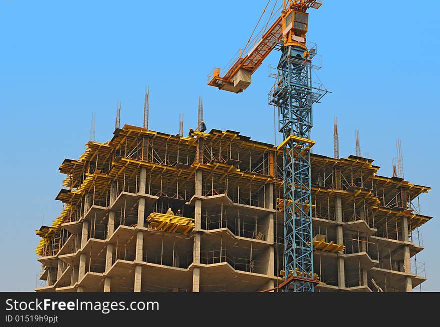 Monolithic housebuilding with crane against blue sky