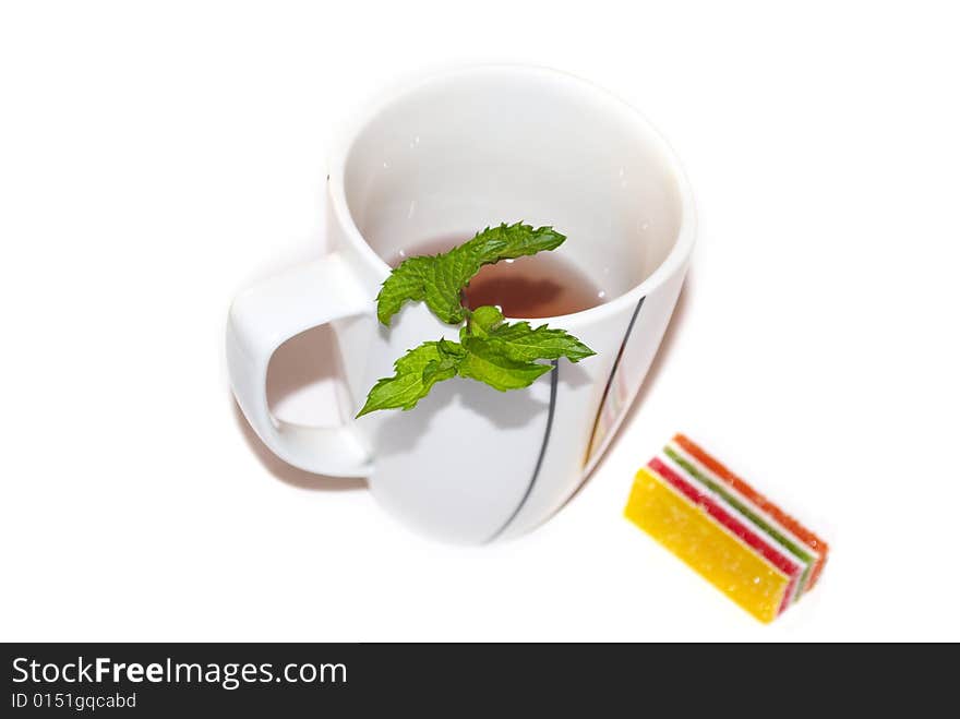 The white tea cup with fresh green mint for breakfast. The white tea cup with fresh green mint for breakfast.