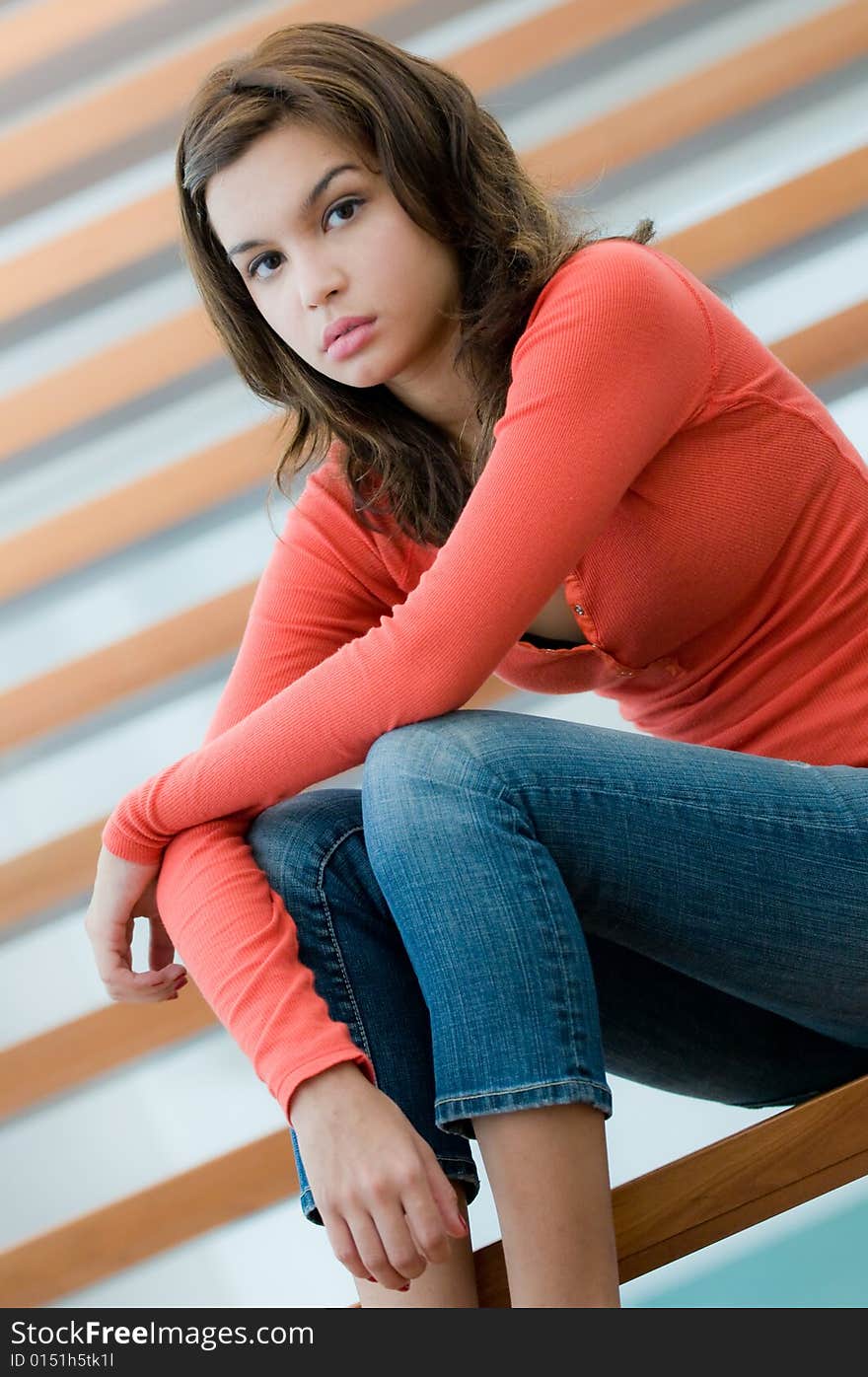 A lifestyle shot of a woman at home on the stairs. A lifestyle shot of a woman at home on the stairs