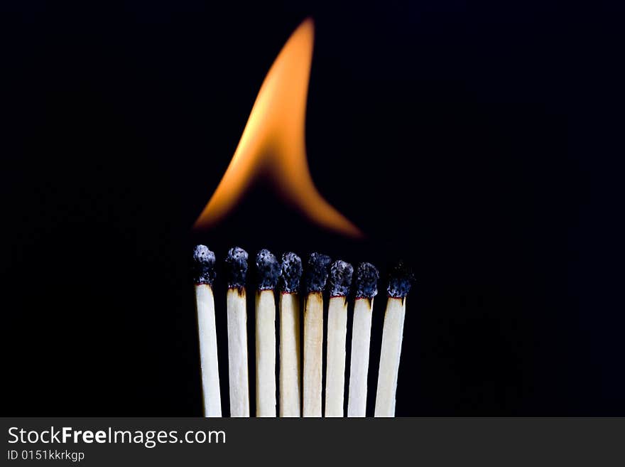 A row of matches burning. A row of matches burning