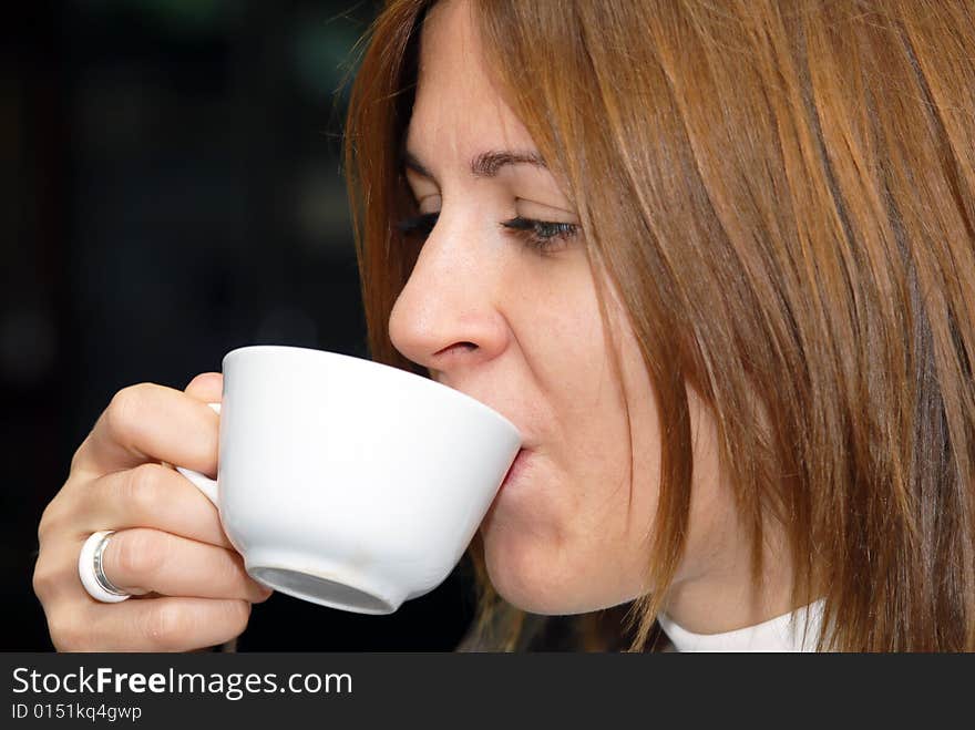 Attractive female enjoying a cup of coffee