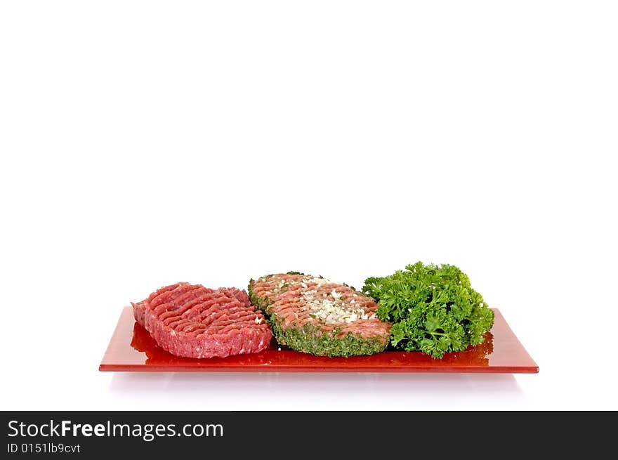 Hamburgers with and without onion on red plate, white background, studio shot, copy space. Hamburgers with and without onion on red plate, white background, studio shot, copy space