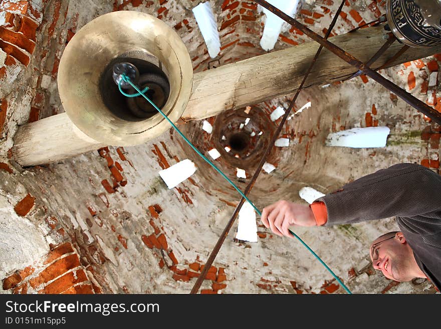 Bell-ringer at belfry of the old Russian Orthodox Church