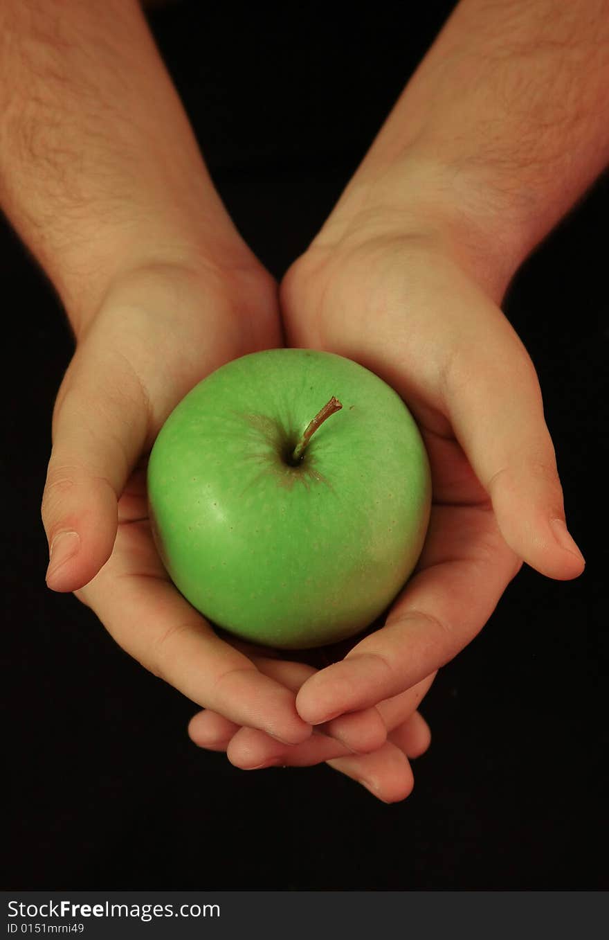 Hands holding fresh, green apple