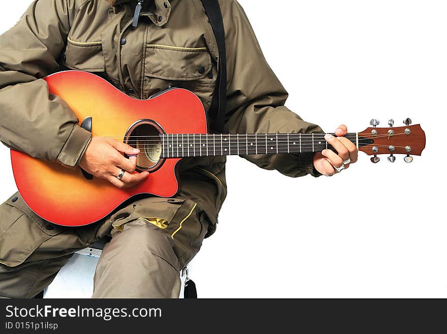 Guitar player in winter jacket sitting on fishing box. Guitar player in winter jacket sitting on fishing box