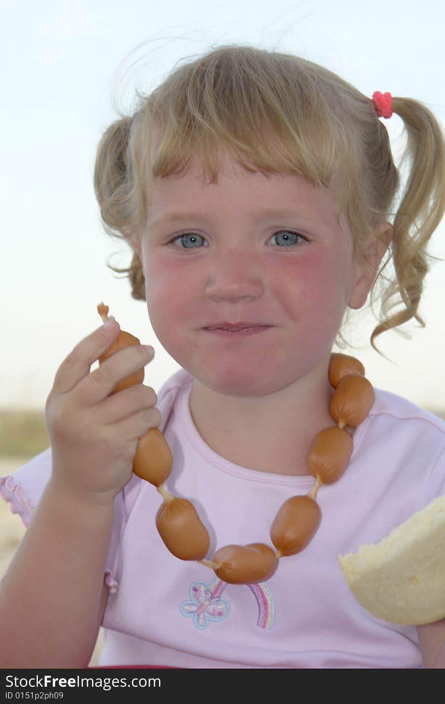 The girl with sausages on a white background