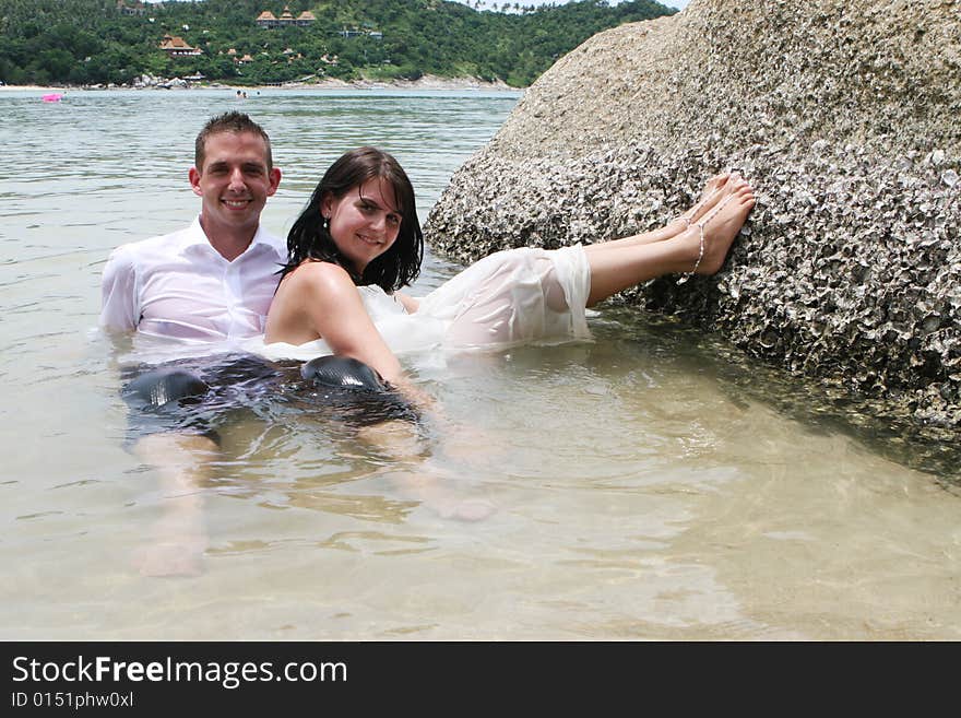 Happy bride and groom during a trash the dress photo shoot.