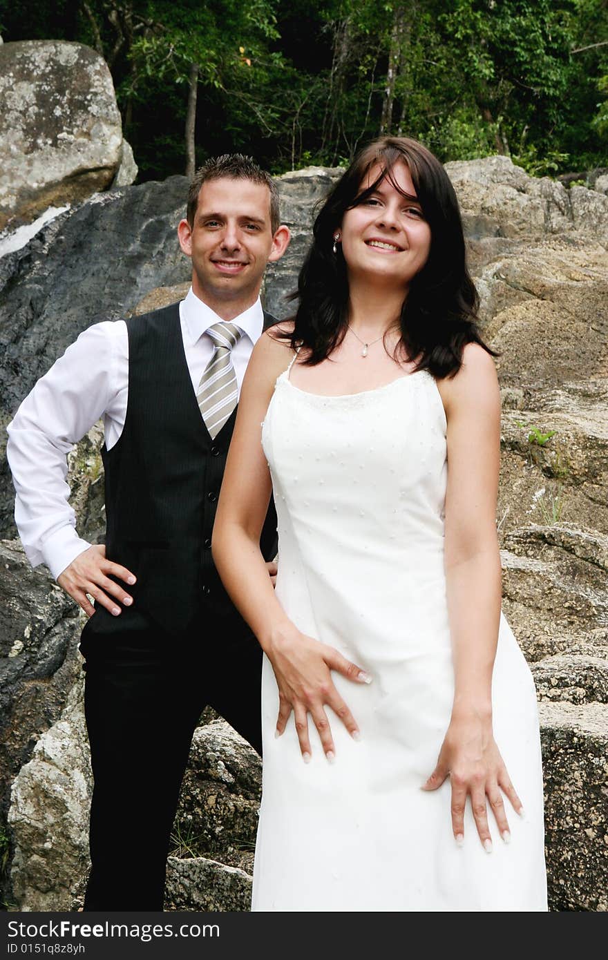 Happy bride and groom on top of a mountain.