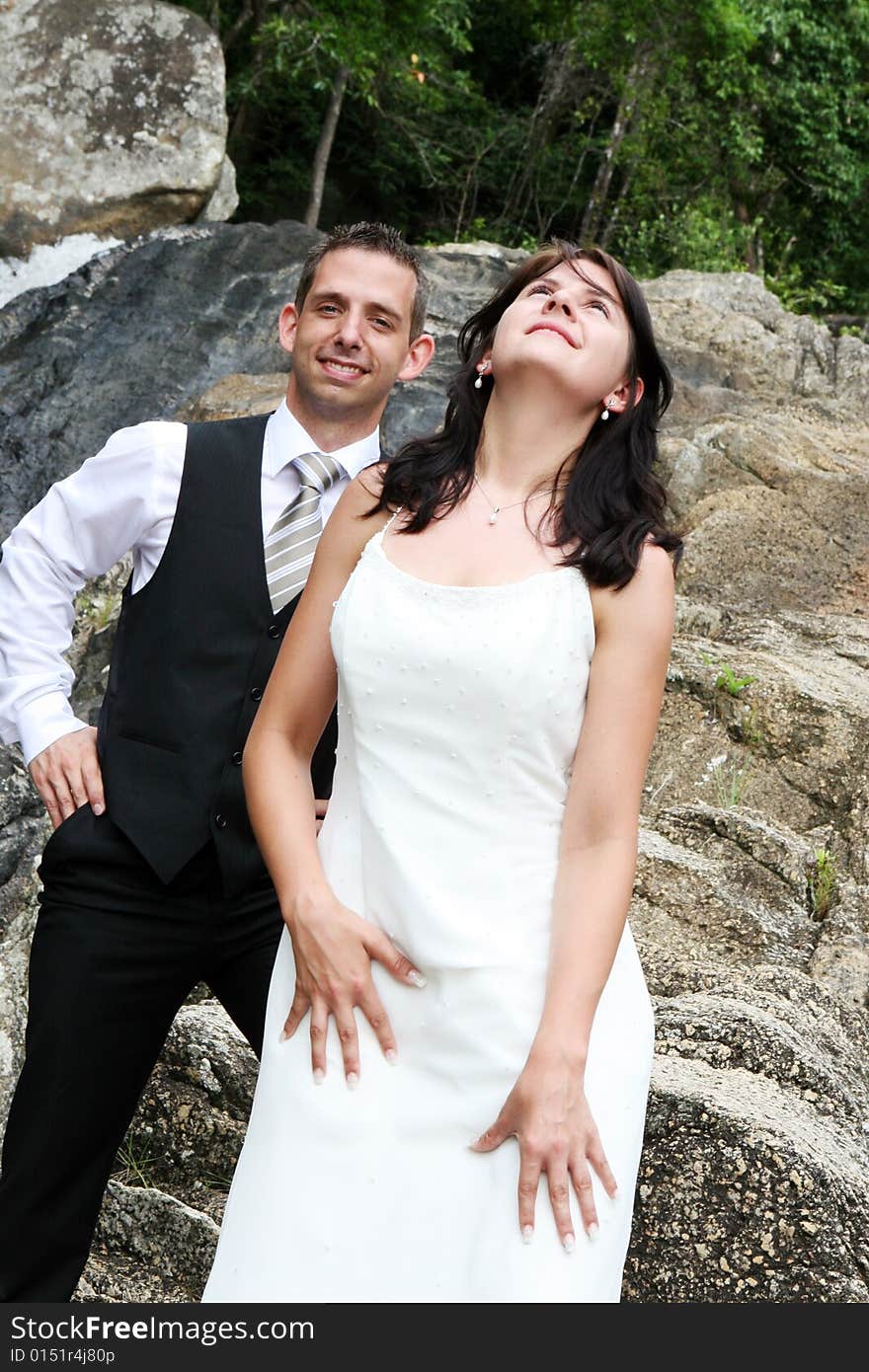 Bride and groom on top of a mountain.