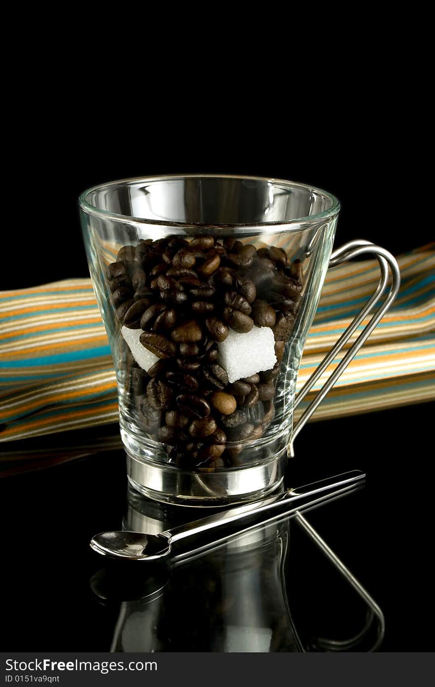 Coffee-beans in a cup with nub-sugar. Coffee-beans in a cup with nub-sugar