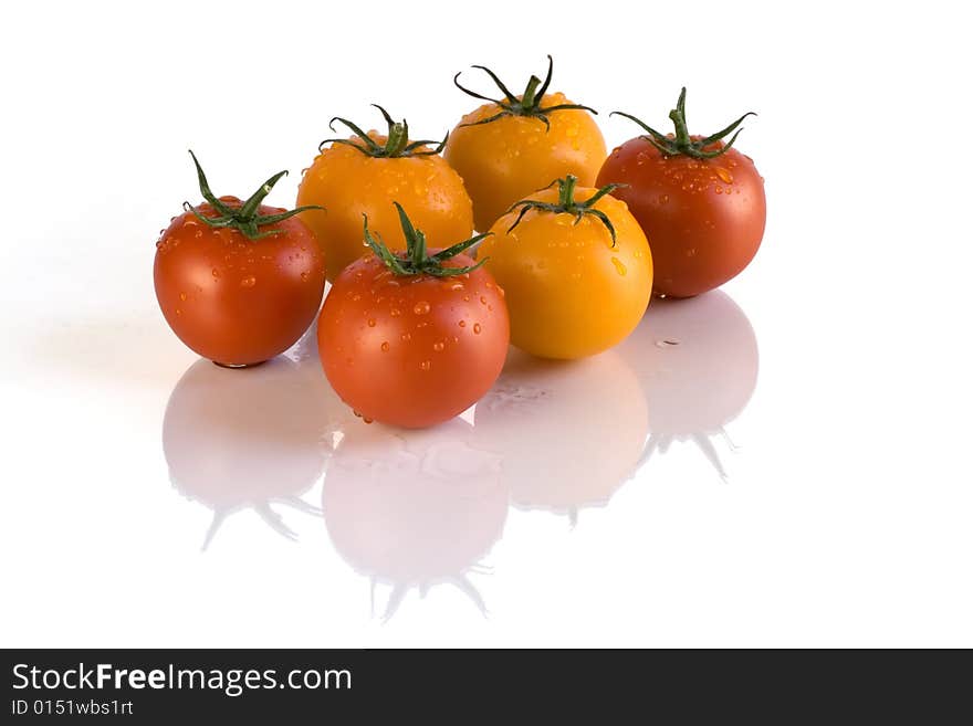 Red and yellow tomatoes with white background. Red and yellow tomatoes with white background