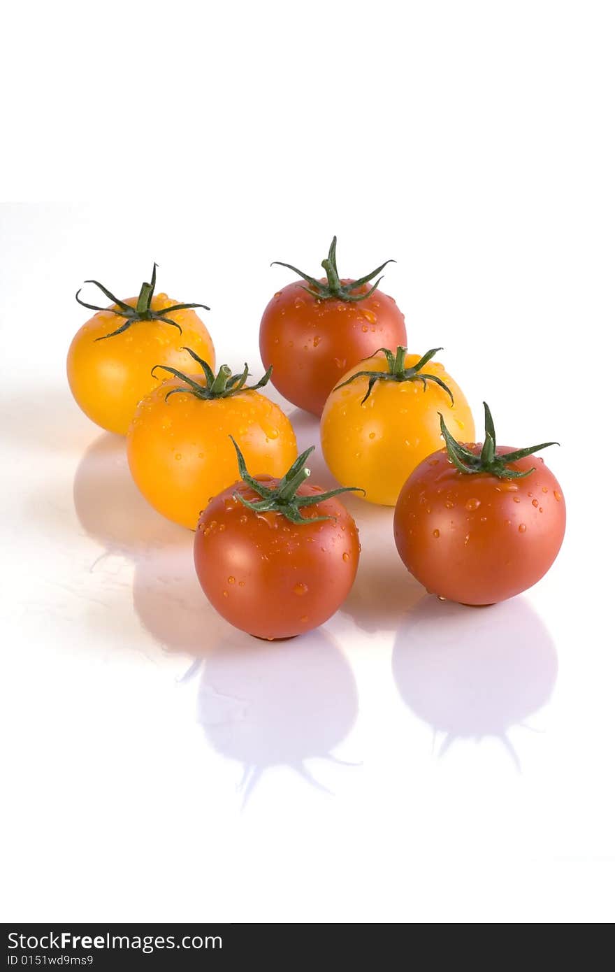 Red and yellow tomatoes with white background. Red and yellow tomatoes with white background