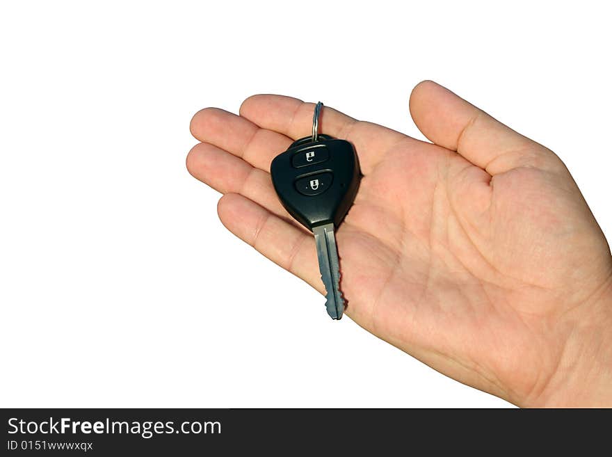 The black car key with buttons lies on a man's hand. White background. The black car key with buttons lies on a man's hand. White background