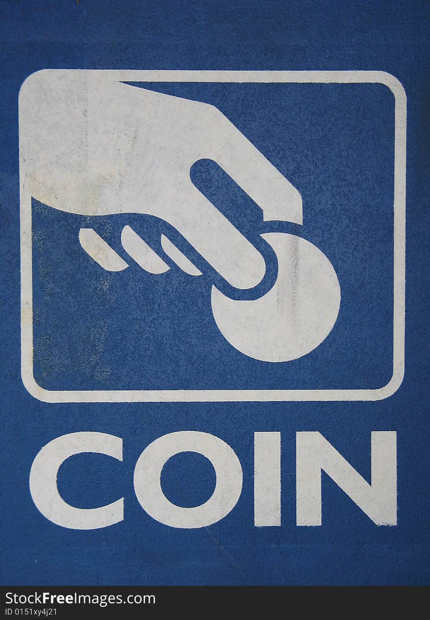 A vertical blue and white coin sign. A vertical blue and white coin sign