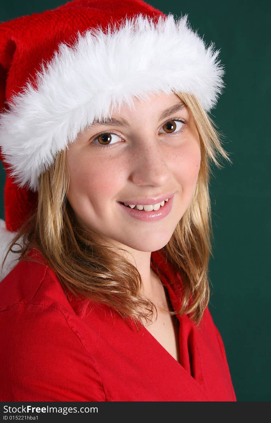 Beautiful teenager wearing a red shirt and christmas hat. Beautiful teenager wearing a red shirt and christmas hat