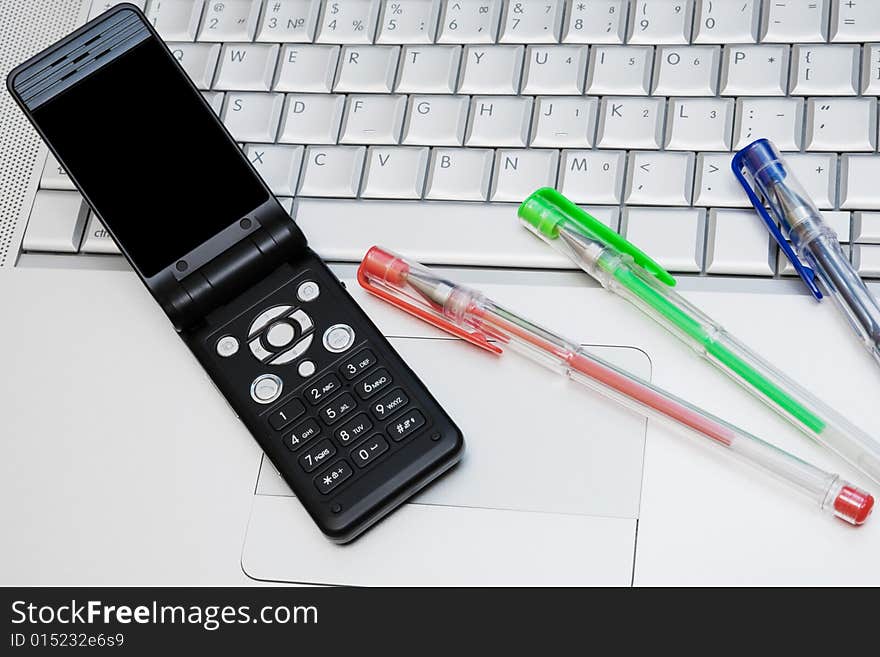 Mobile phone on the keyboard of a computer. Mobile phone on the keyboard of a computer