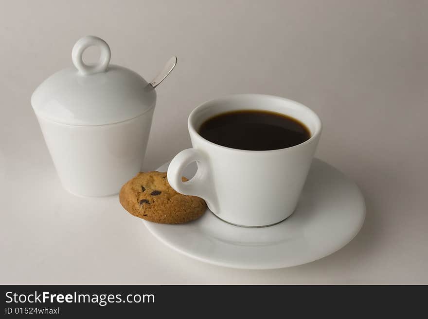 Cup of black coffee with cookies