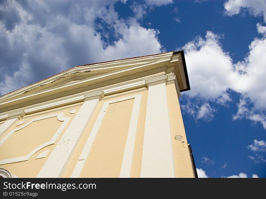 Old church on the cloudy sky background