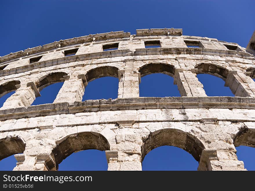 Famous italian amphitheater on the blue sky background. Famous italian amphitheater on the blue sky background