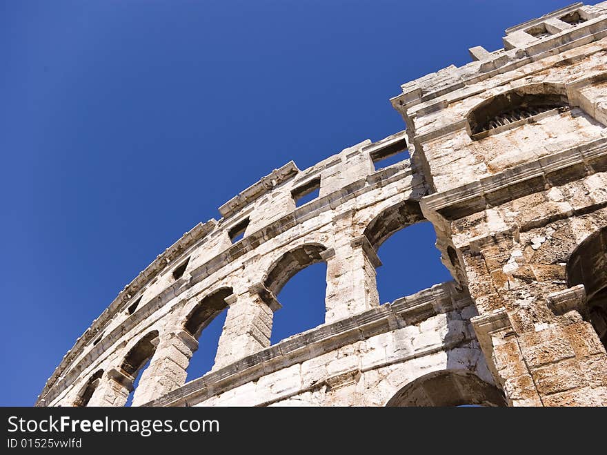 Famous italian amphitheater on the blue sky background. Famous italian amphitheater on the blue sky background