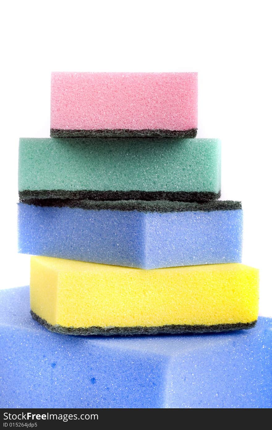 Five colorful bath sponges close-up isolated on white background