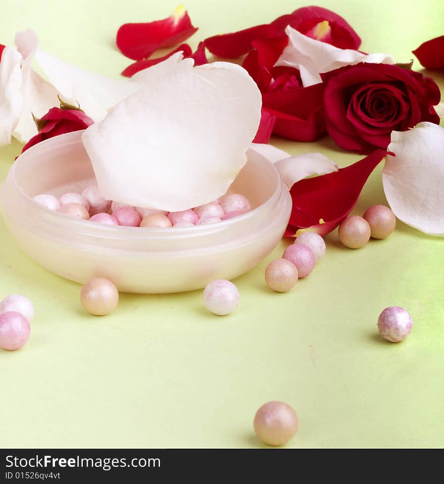 Red and white rose petals and heads with pouder isolated on light background. Red and white rose petals and heads with pouder isolated on light background