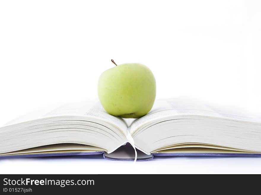 Apple with green book on white background. Apple with green book on white background