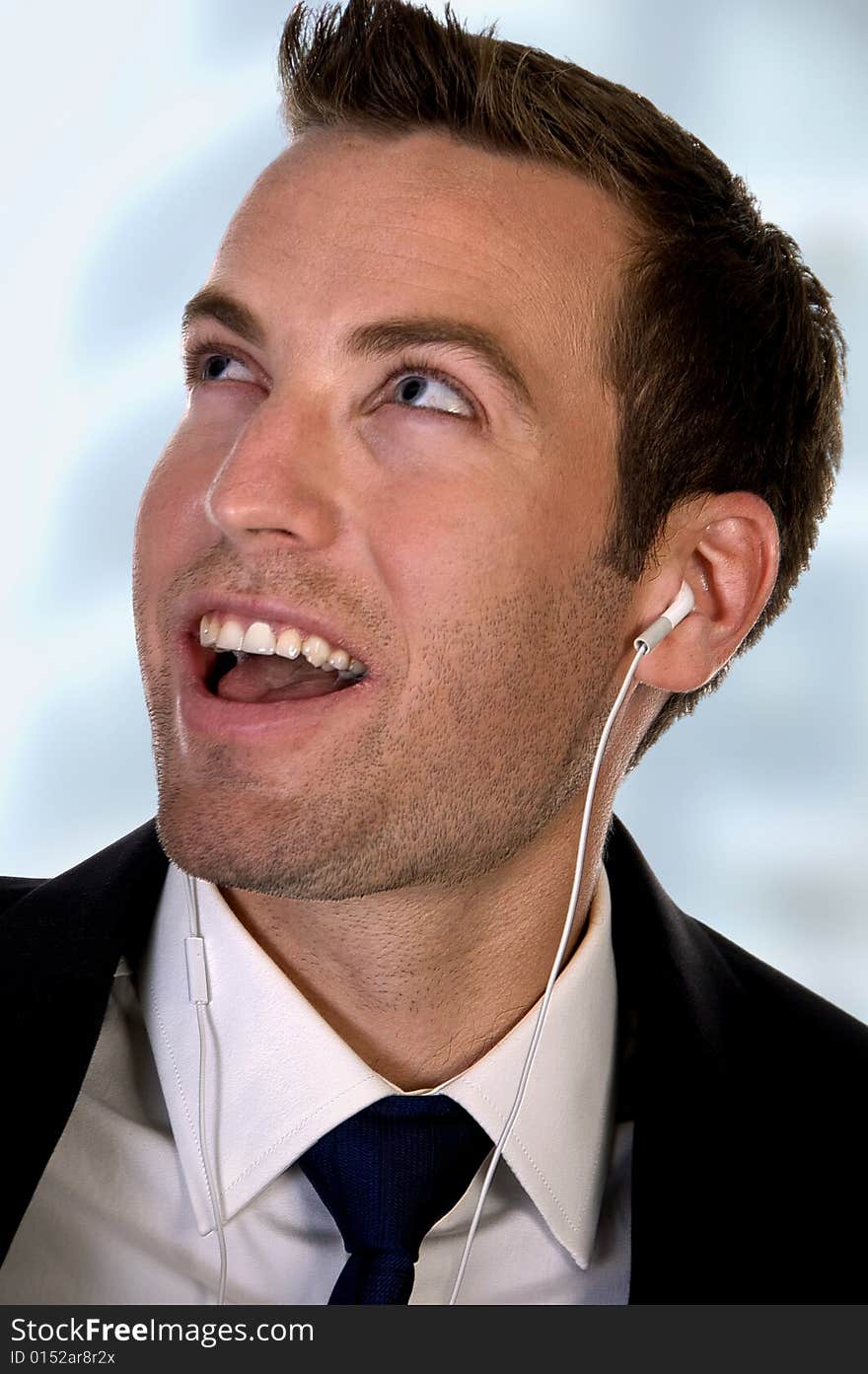 Portrait of businessman listening music