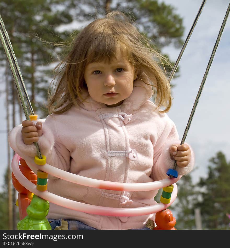 Young girl having fun on swing. Young girl having fun on swing.