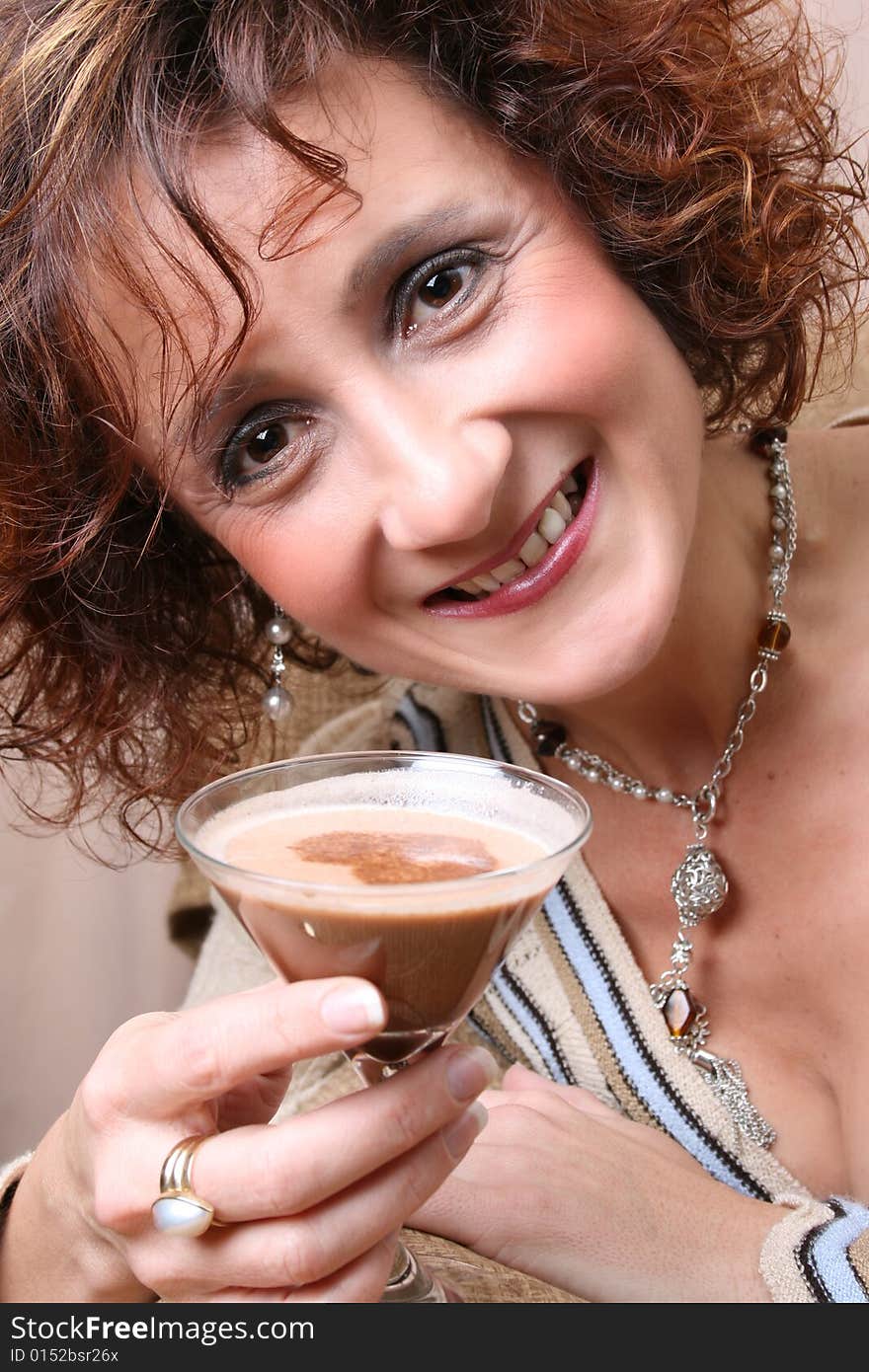 Mature female with a chocolate drink in her hand