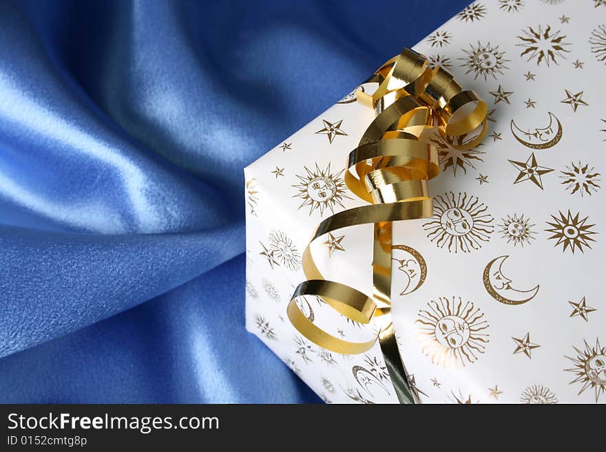 Wrapped Christmas present with a golden ribbon. Wrapped Christmas present with a golden ribbon