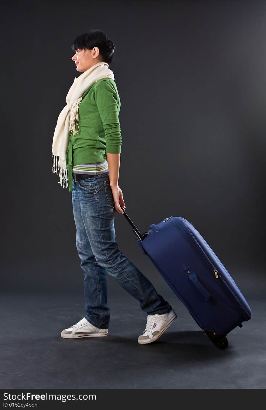 The Young Girl In A Scarf And Jeans With A Dark Bl