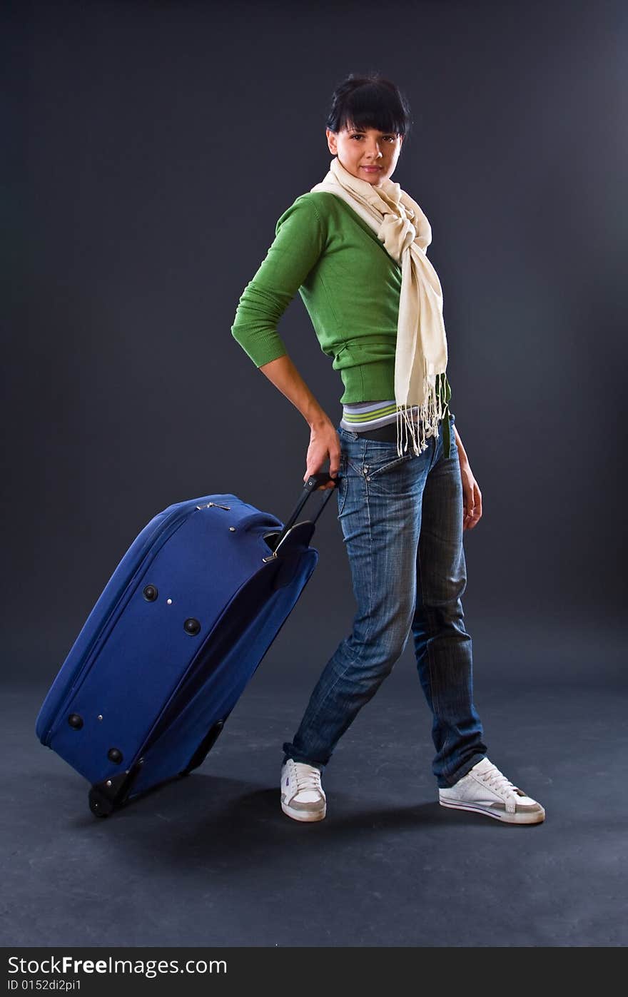 The young girl in a scarf and jeans with a dark bl