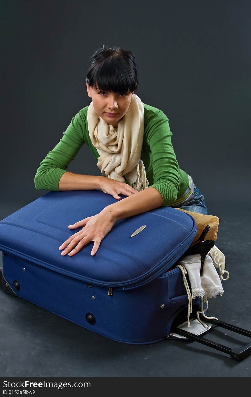 The Young Girl In A Scarf And Jeans With A Dark Bl