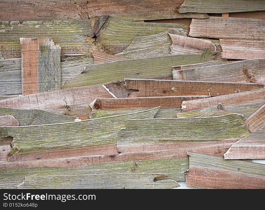 An old shed repaired with pieces of broken wooden planks. An old shed repaired with pieces of broken wooden planks.